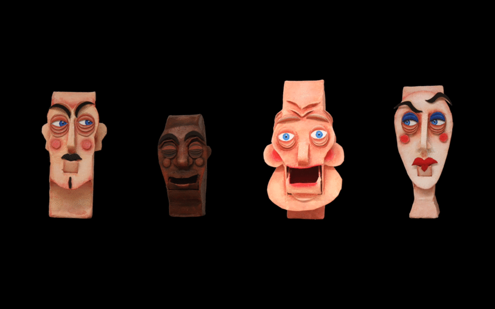 Stopmotion animated gif of cardboard heads spinning on black backdrop 